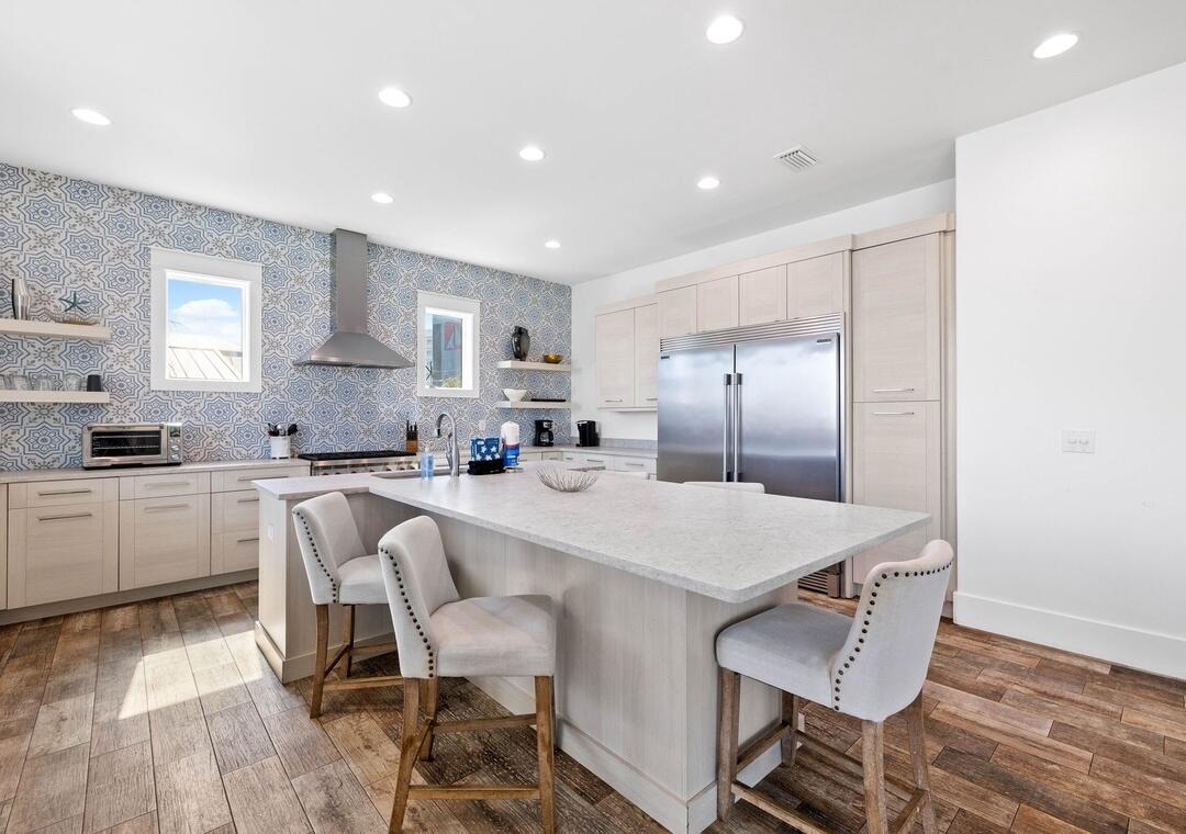 151 Snowdrift Road Miramar Beach, FL 32550 - Photo 6 of 50 a large kitchen with kitchen island a dining table chairs and white cabinets