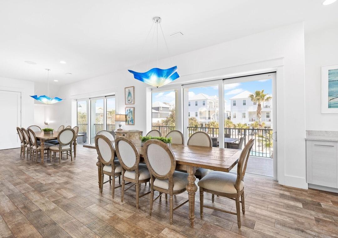 151 Snowdrift Road Miramar Beach, FL 32550 - Photo 8 of 50 a dining room with furniture a chandelier and wooden floor