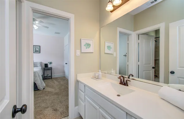 a en suite bathroom with a sink and a mirror