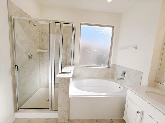 a view of a house with a yard potted plants and a table