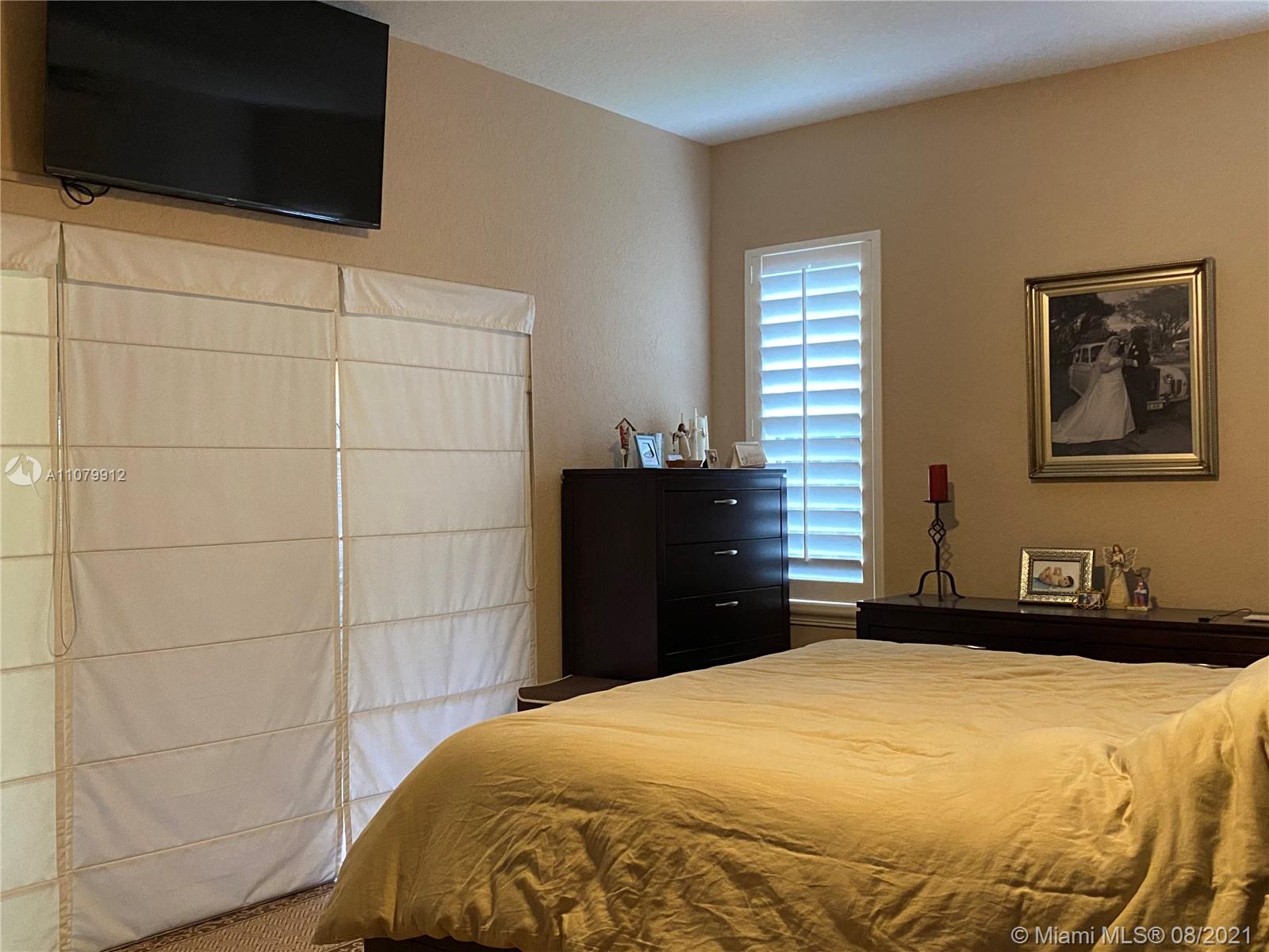 West Kendall Miami, FL 33193 - Photo 8 of 8 a bedroom with a bed and a flat screen tv