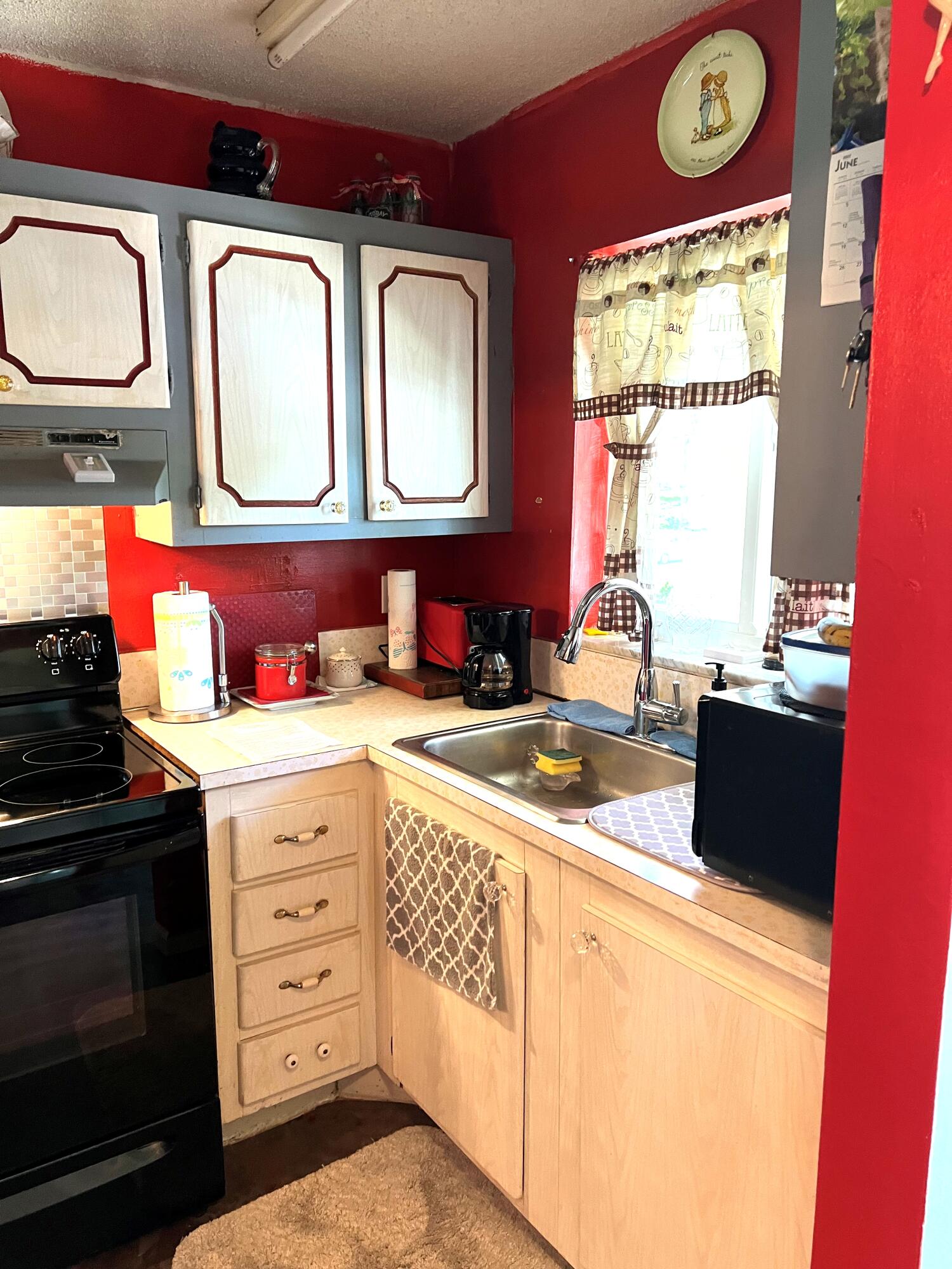 9855 Sandalfoot Boulevard, Unit 313 Boca Raton, FL 33428 - Photo 4 of 18 a kitchen with stainless steel appliances a stove a sink and a microwave