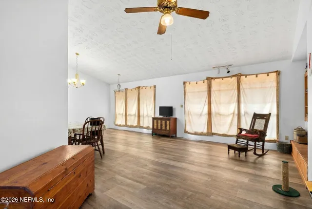 a living room with furniture and floor to ceiling window