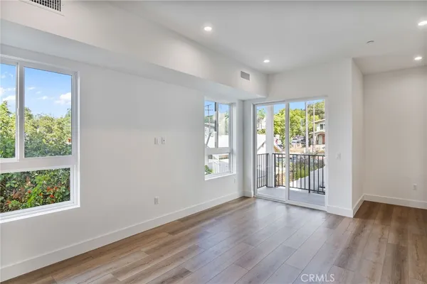a view of a room with wooden floor and window