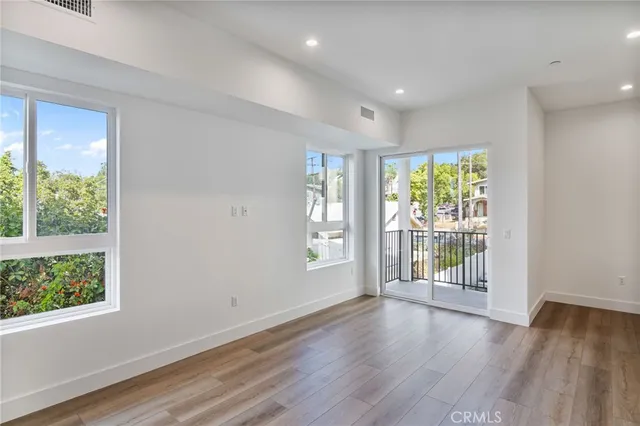 a view of a room with wooden floor and window
