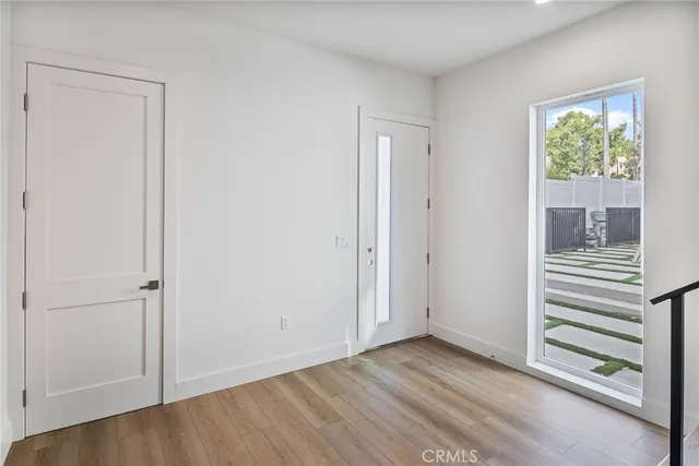 a view of an empty room with wooden floor