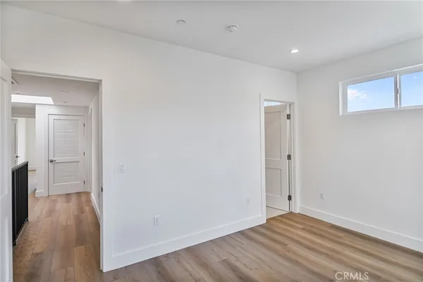 a view of a livingroom with wooden floor and a window