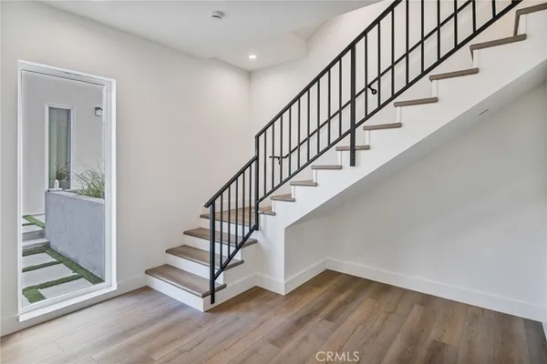 a kitchen with a refrigerator and a stove top oven