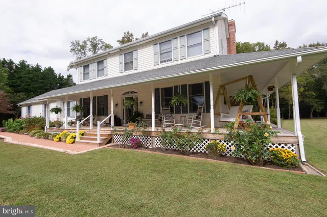 a front view of house with outdoor seating and yard