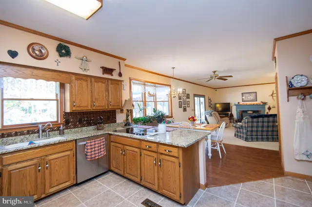 a large kitchen with kitchen island a sink a stove a dining table and chairs