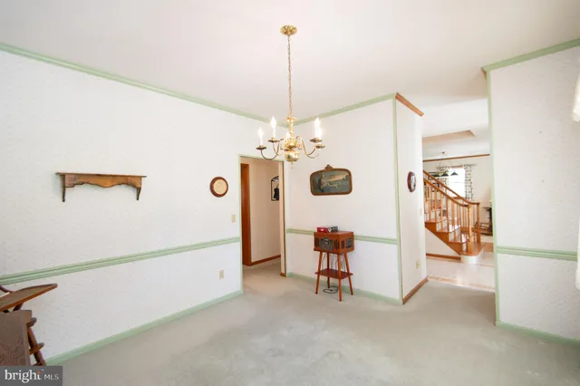 a view of a livingroom with furniture and a chandelier