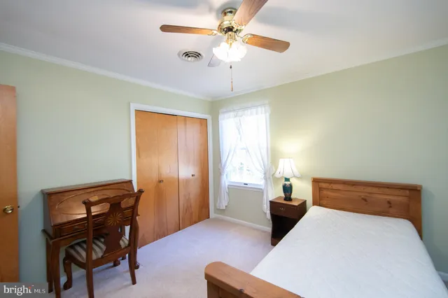 a bedroom with a bed and a chair