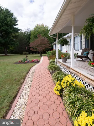 a view of a backyard with sitting area