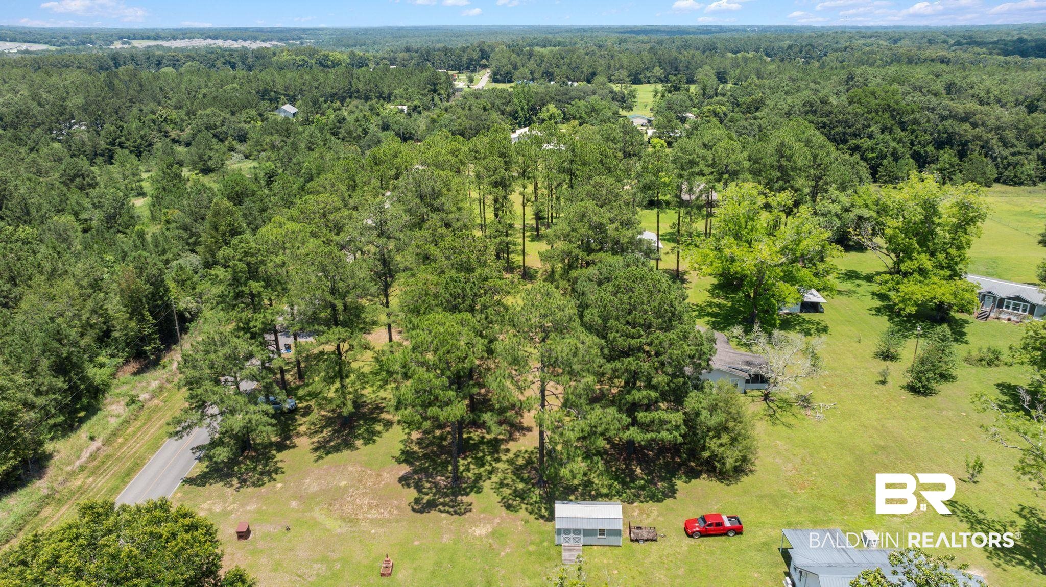 20540 Lacey Road Silverhill, AL 36576 - Photo 33 of 40 Expansive property featuring a mix of mature trees and open grassy areas