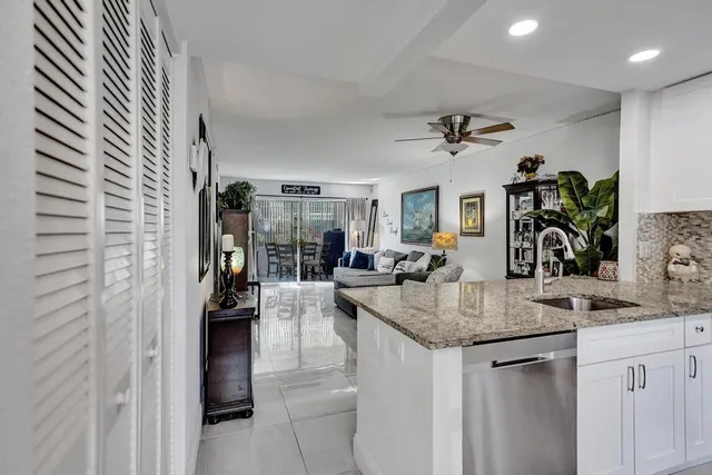 a kitchen with sink and refrigerator