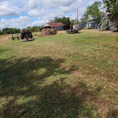 a view of a field with an trees
