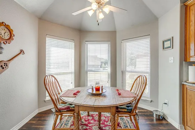 a dining room with furniture a chandelier and wooden floor