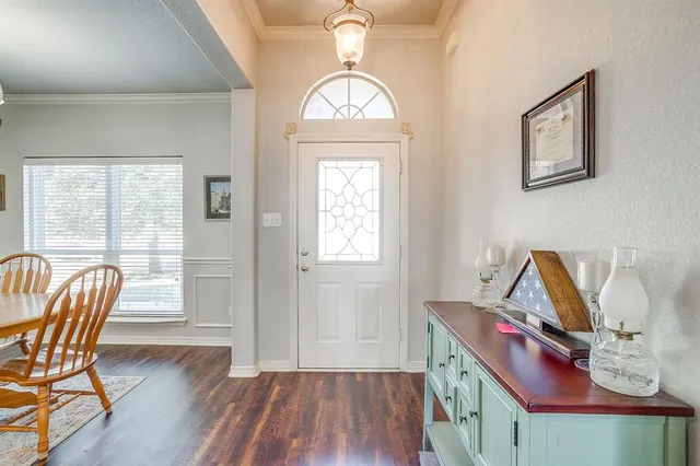 a view of a dining room with furniture a chandelier and wooden floor