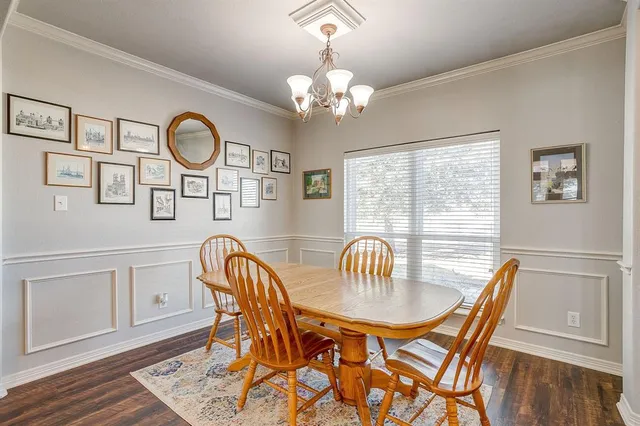 a dining room with furniture a chandelier and wooden floor
