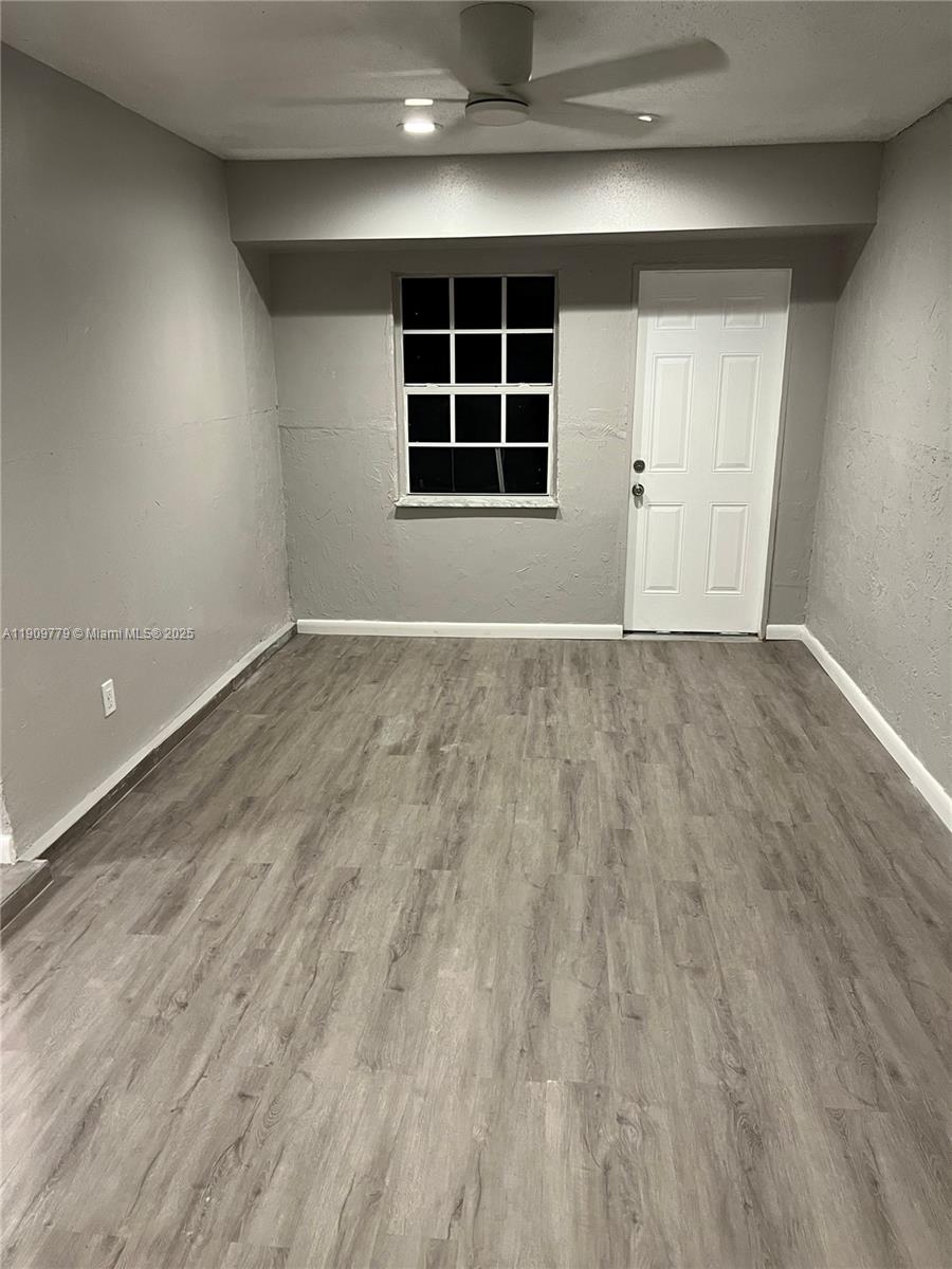 417 Southwest 8th Avenue Delray Beach, FL 33444 - Photo 11 of 18 an empty room with wooden floor and windows