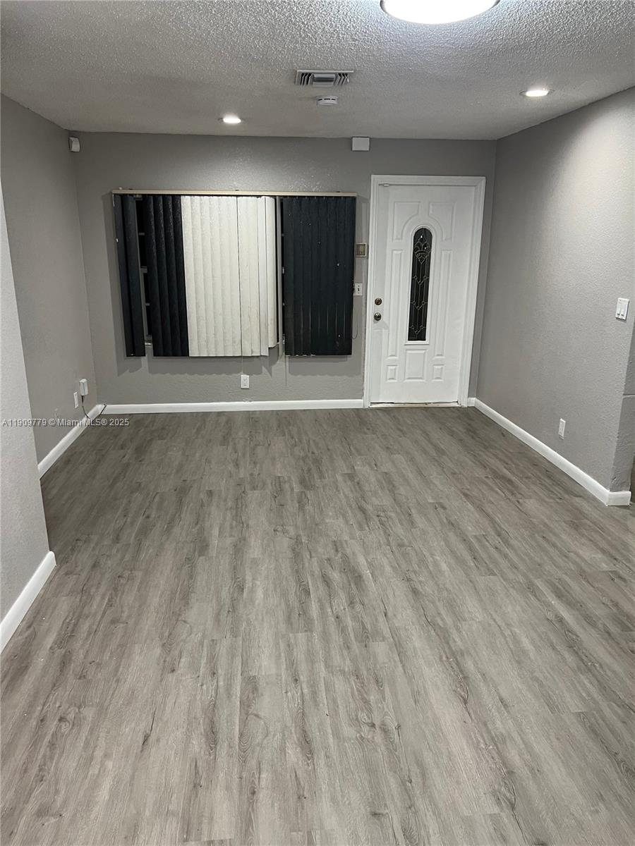 417 Southwest 8th Avenue Delray Beach, FL 33444 - Photo 14 of 18 an empty room with wooden floor and windows