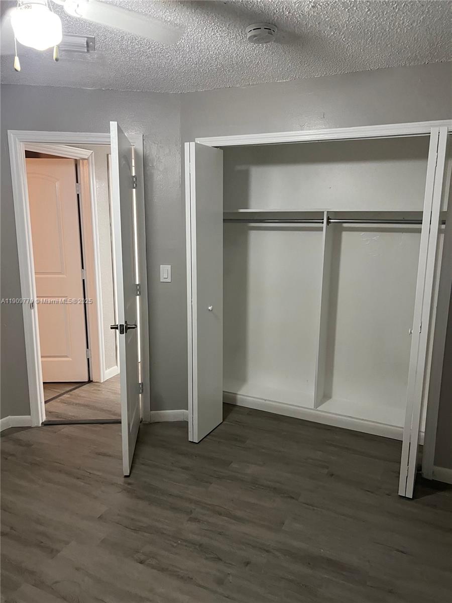 417 Southwest 8th Avenue Delray Beach, FL 33444 - Photo 5 of 18 a view of an empty room with wooden floor and a bathroom