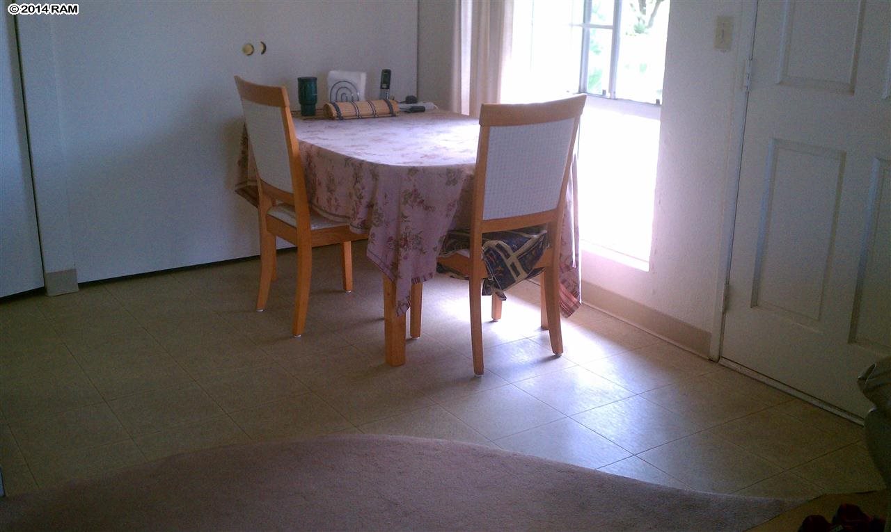 140 Uwapo Road, Unit 1201 Kihei, HI 96753 - Photo 4 of 8 a dining room with furniture and wooden floor