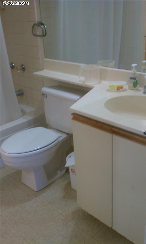 140 Uwapo Road, Unit 1201 Kihei, HI 96753 - Photo 6 of 8 a white toilet sitting next to a bathroom sink