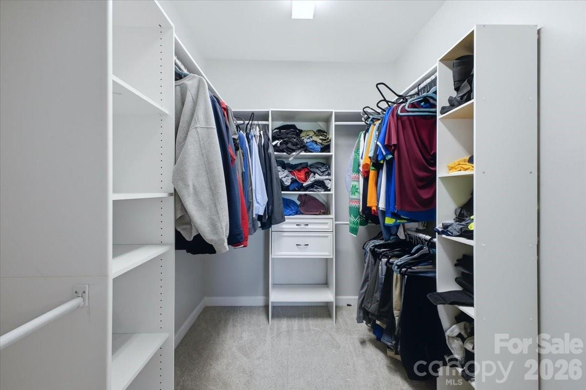 1825 Laveta Road Charlotte, NC 28269 - Photo 23 of 48 a view of walk in closet with clothes and shoes