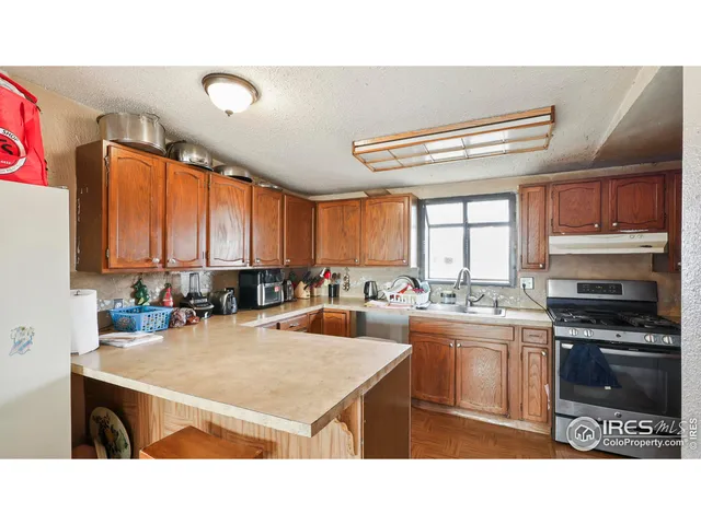 a kitchen with a stove a sink and a refrigerator