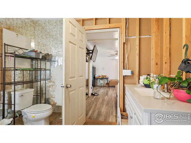 a bathroom with a toilet a sink and shower