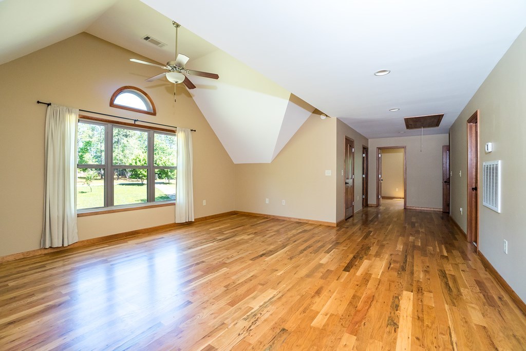1309 Charles Johnson Road Forsyth, GA 31029 - Photo 22 of 29 a view of empty room with wooden floor and fan