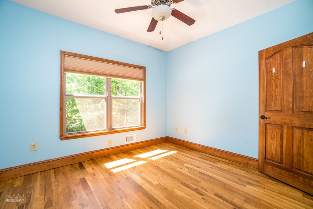 1309 Charles Johnson Road Forsyth, GA 31029 - Photo 8 of 29 a view of an empty room with wooden floor and a window