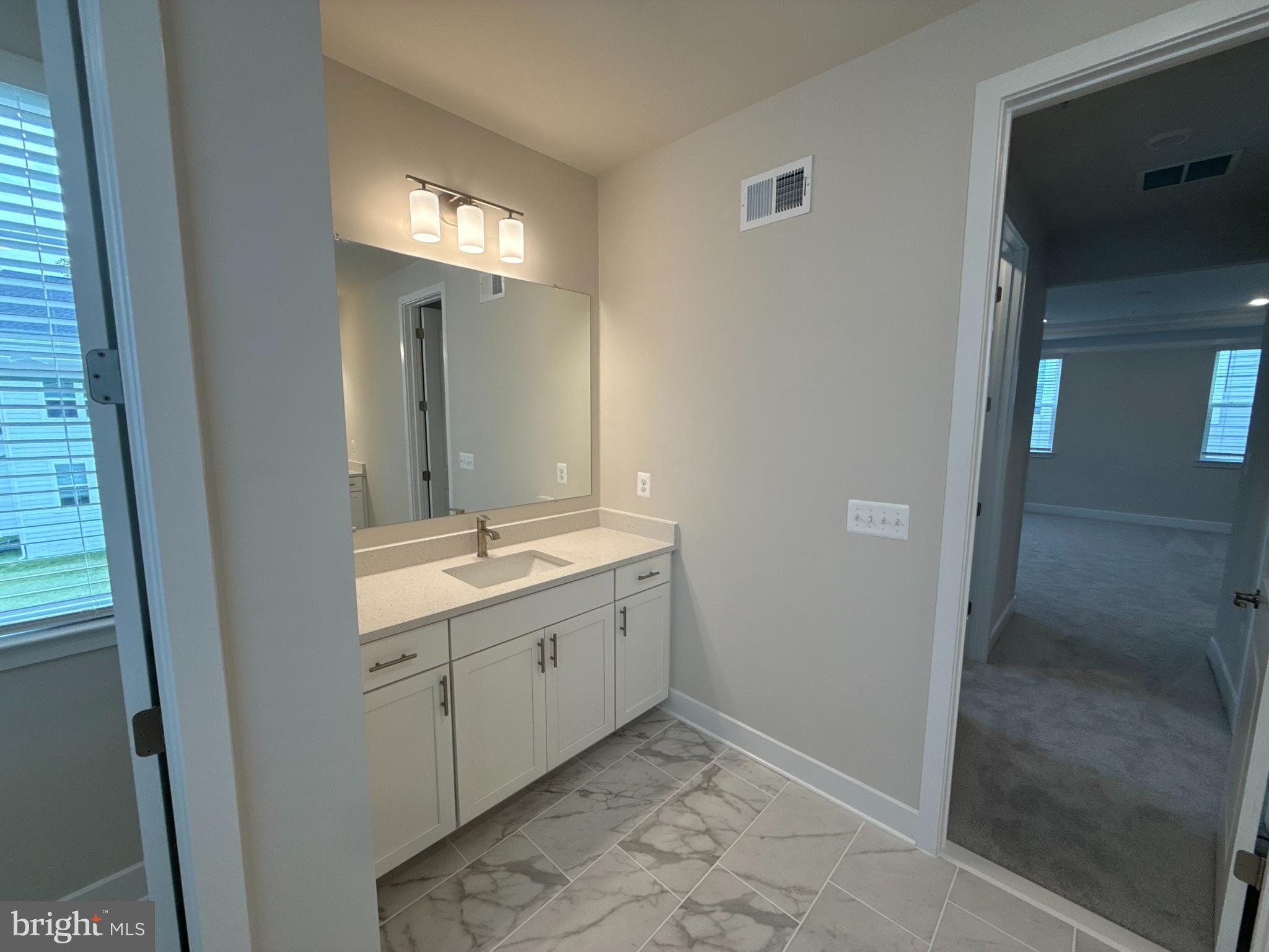 116 Stilly Way Annapolis, MD 21403 - Photo 10 of 21 a bathroom with a double vanity sink and a mirror