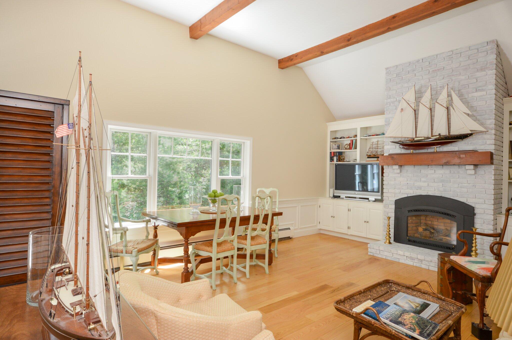 a living room with furniture a fireplace and a large window