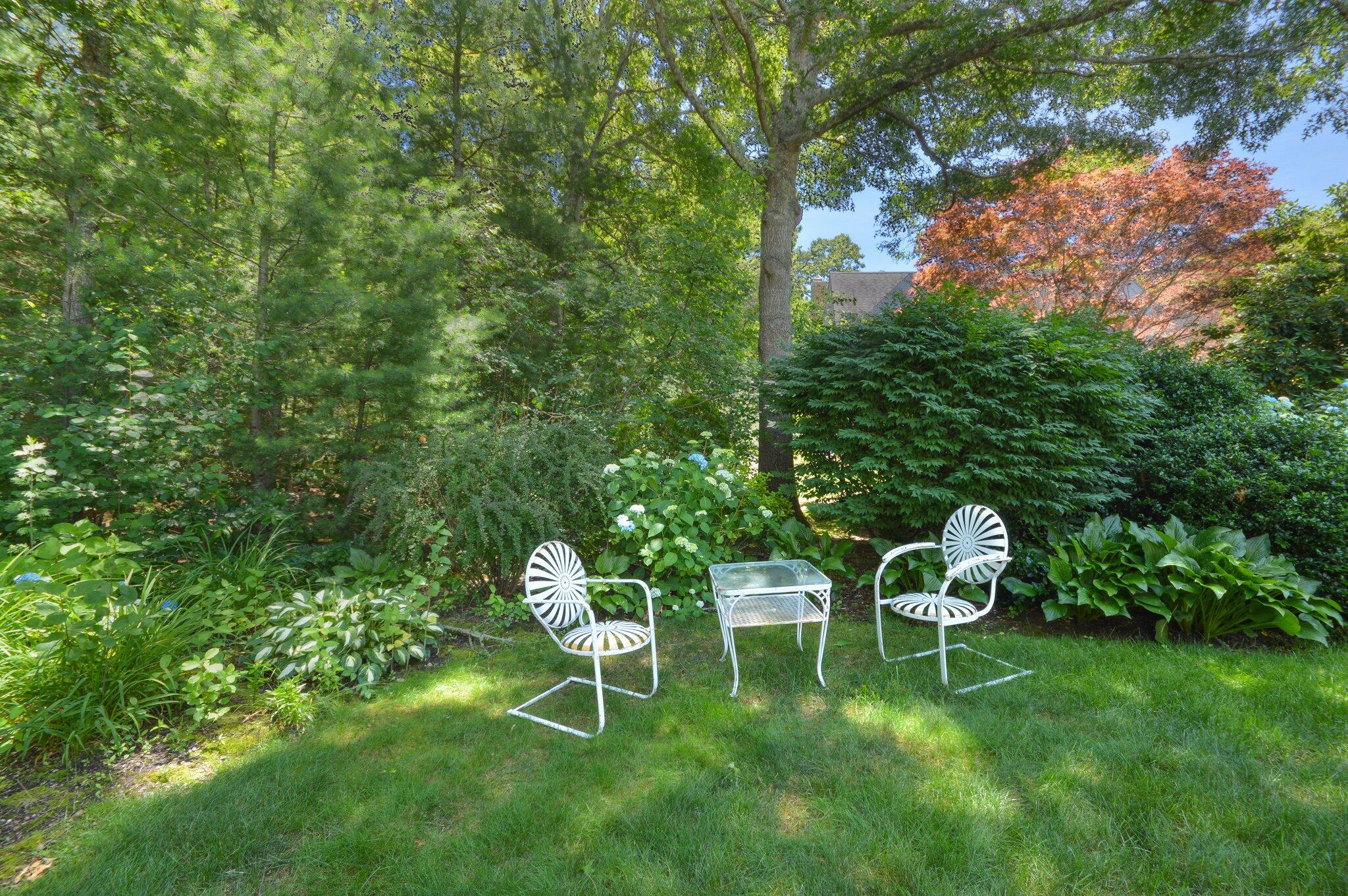 53 Hyde Road Centerville, MA 02632 - Photo 11 of 17 a table and chairs in a garden