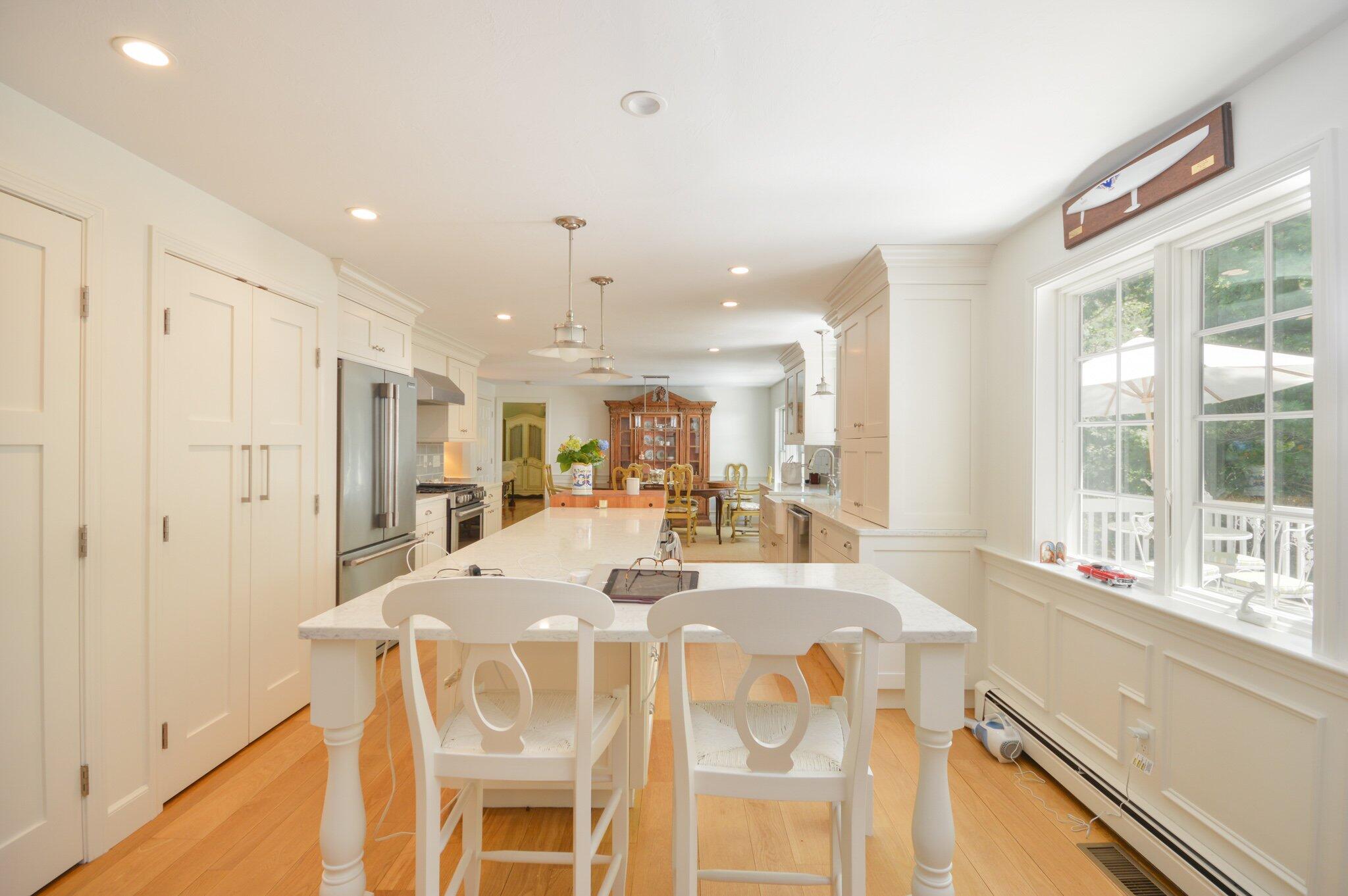 53 Hyde Road Centerville, MA 02632 - Photo 6 of 17 a dining hall with stainless steel appliances kitchen island granite countertop a dining table and chairs