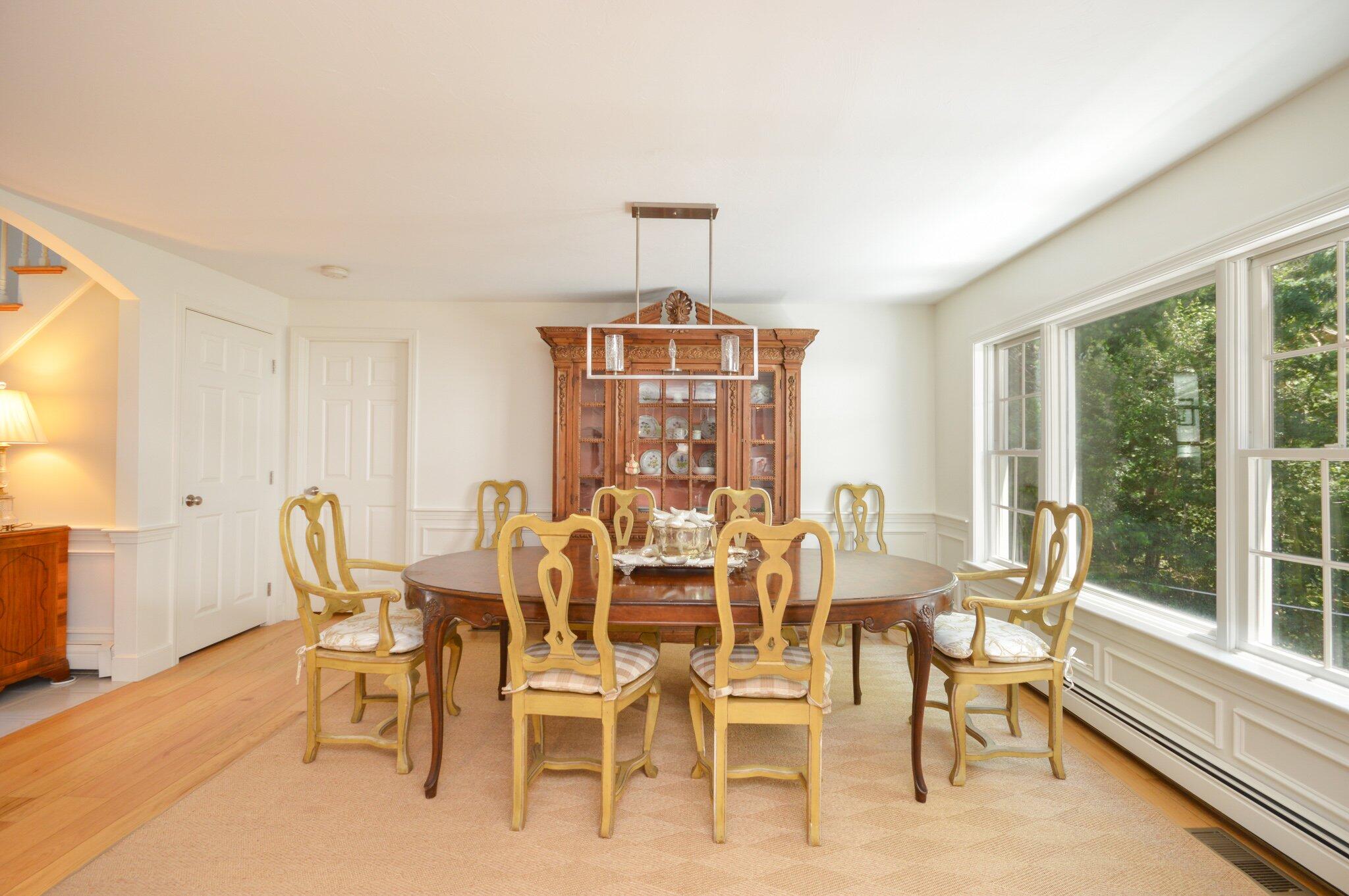 53 Hyde Road Centerville, MA 02632 - Photo 7 of 17 a dining room with furniture a chandelier and wooden floor