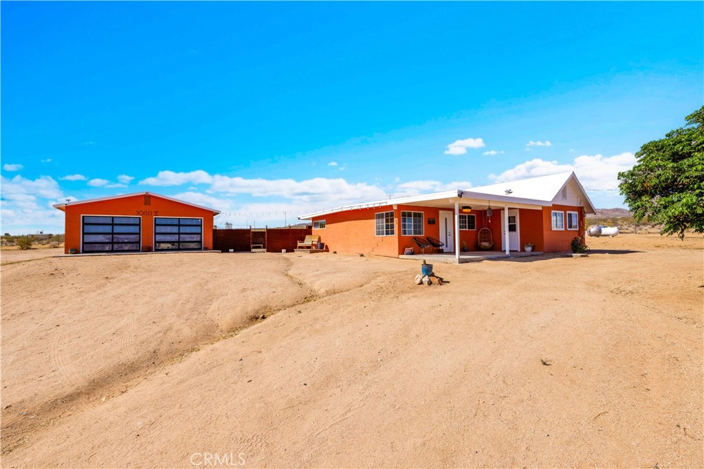 55850 Shannon Road Landers, CA 92285 - Photo 1 of 66 a front view of a house with large trees