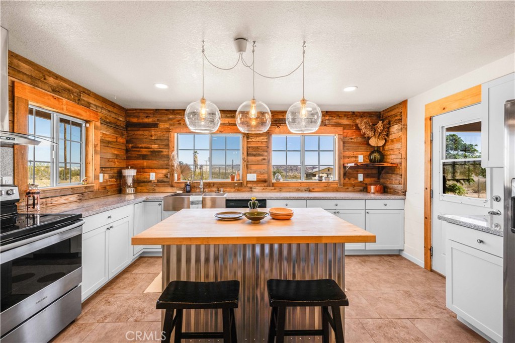 55850 Shannon Road Landers, CA 92285 - Photo 15 of 66 a dining room filled with large windows