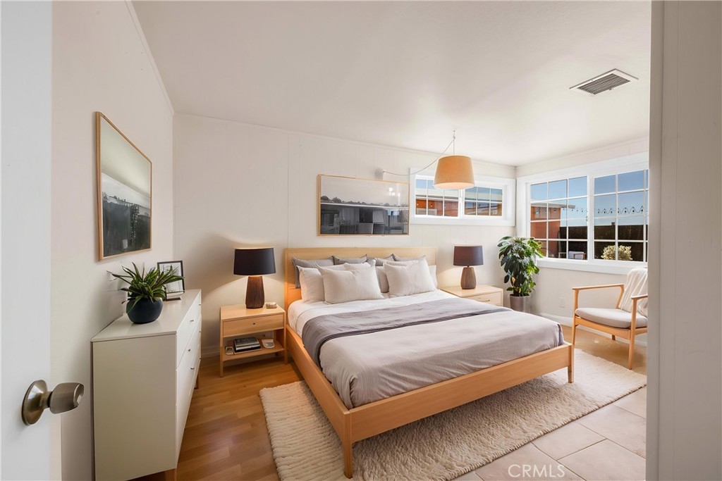 55850 Shannon Road Landers, CA 92285 - Photo 20 of 66 a bedroom with a large bed and a chandelier