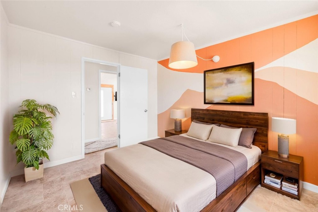 55850 Shannon Road Landers, CA 92285 - Photo 27 of 66 a bedroom with a bed and a potted plant