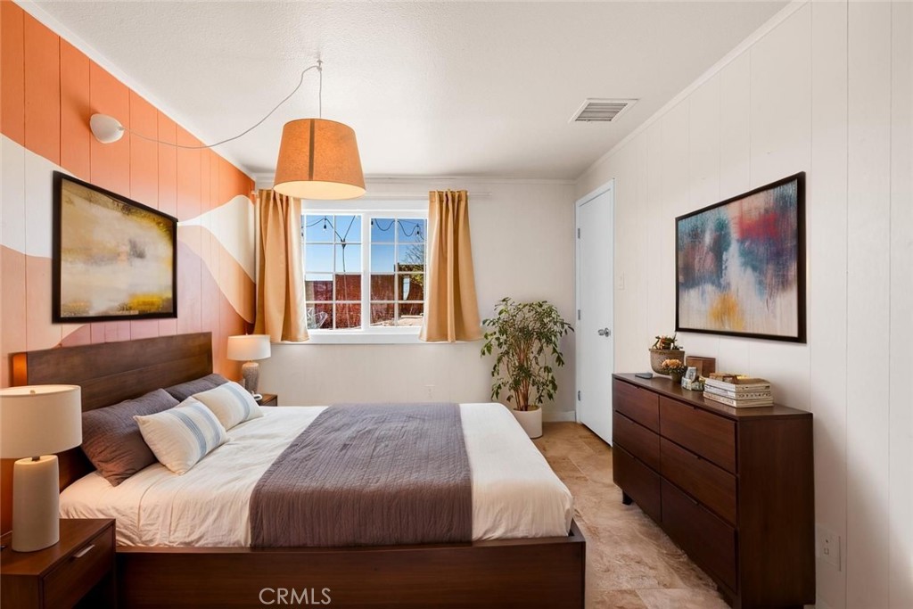 55850 Shannon Road Landers, CA 92285 - Photo 29 of 66 a bedroom with a bed and wooden floor