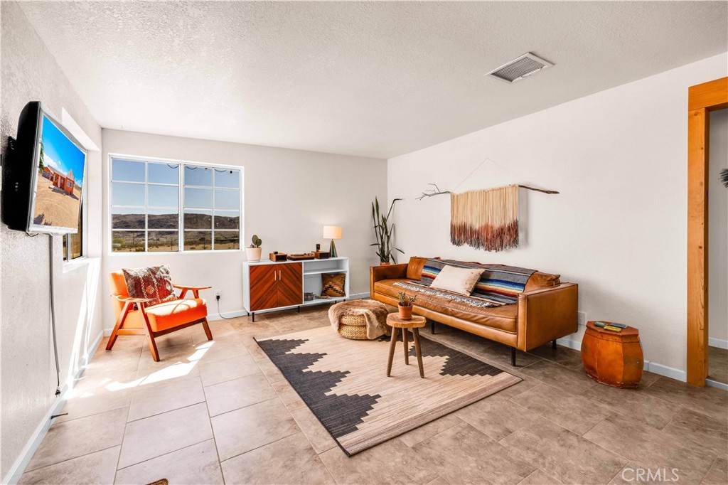 55850 Shannon Road Landers, CA 92285 - Photo 7 of 66 a living room with furniture and a flat screen tv