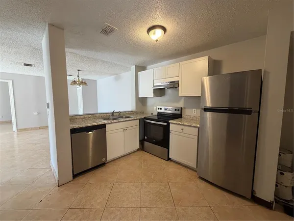 a kitchen with a refrigerator stove and sink
