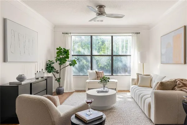 a living room with furniture and a large window