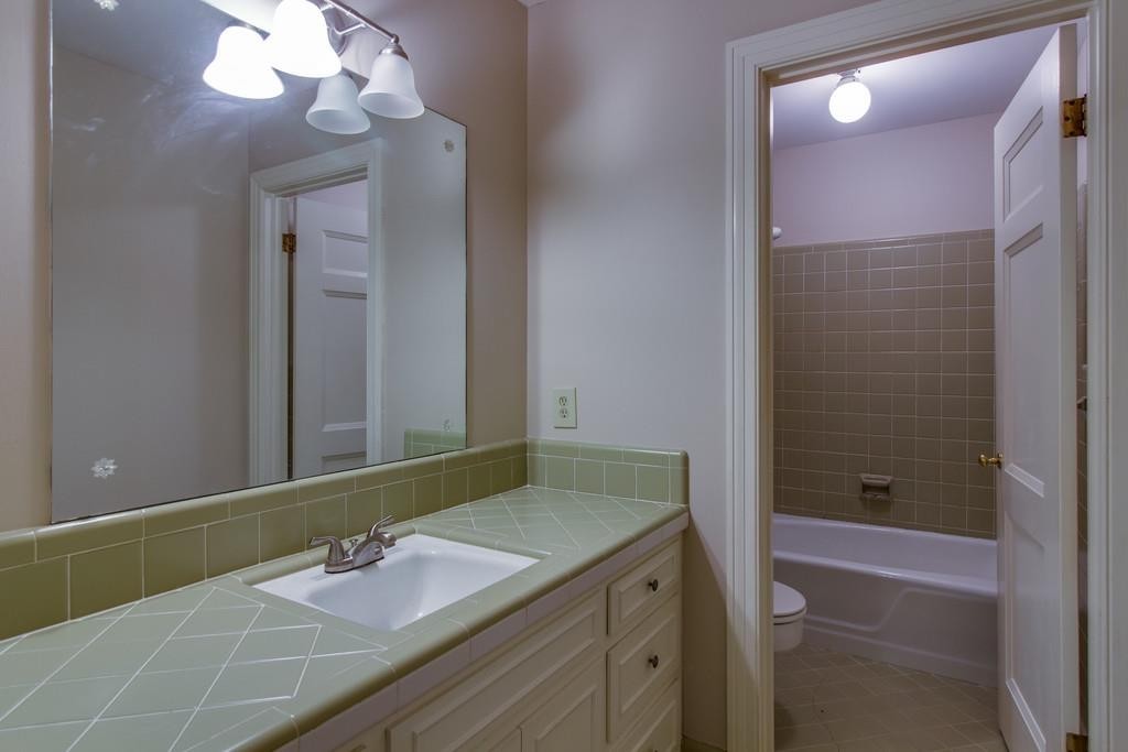 1501 Hillsboro Road Franklin, TN 37069 - Photo 16 of 24 a bathroom with a granite countertop sink a shower and a mirror