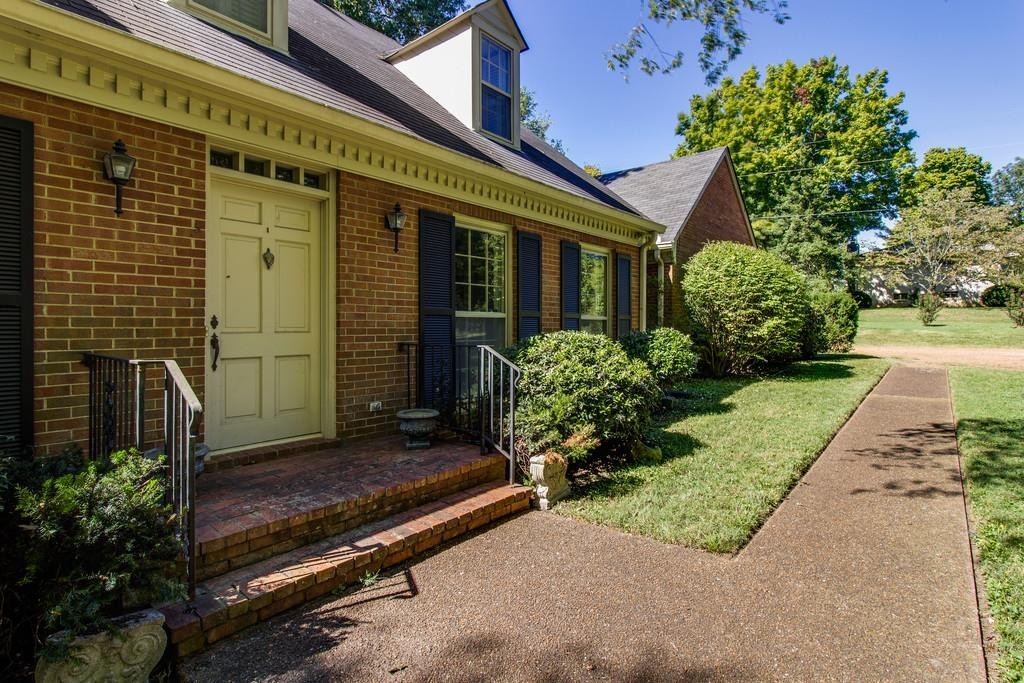 1501 Hillsboro Road Franklin, TN 37069 - Photo 2 of 24 a front view of a house with a garden