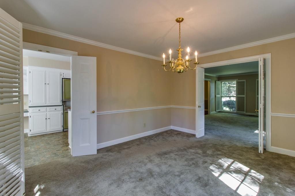 1501 Hillsboro Road Franklin, TN 37069 - Photo 8 of 24 an empty room that has a chandelier in it