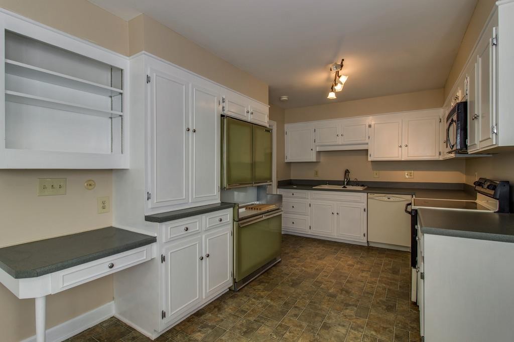 1501 Hillsboro Road Franklin, TN 37069 - Photo 9 of 24 a kitchen with granite countertop white cabinets and white appliances